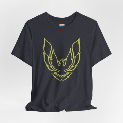 The Pontiac Trans Am Phoenix Shirt - Unisex Jersey Short Sleeve Tee by Printify is a classic black T-shirt that showcases a stylized yellow phoenix design on the front, reminiscent of the iconic Pontiac Trans Am. The shirt is displayed laid flat against a white background.