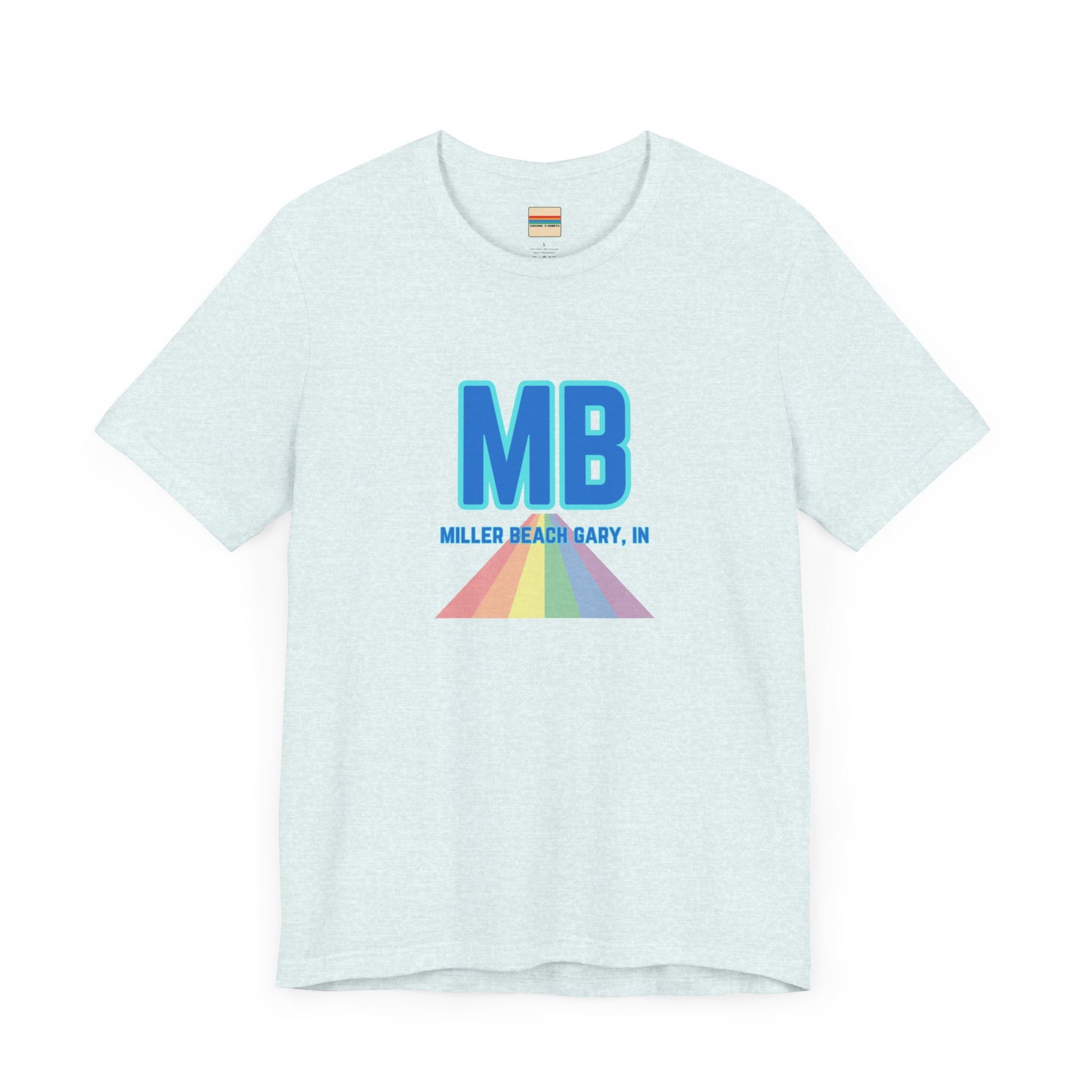 The Miller Beach Pride - Unisex Jersey Short Sleeve Tee by Printify is a white shirt made from 100% Airlume combed cotton. It showcases a design with large, bold blue letters "MB" at the top. Beneath it, the text "MILLER BEACH GARY, IN" is written in blue. A colorful, triangular rainbow graphic extends downward from the text, symbolizing Miller Beach pride.