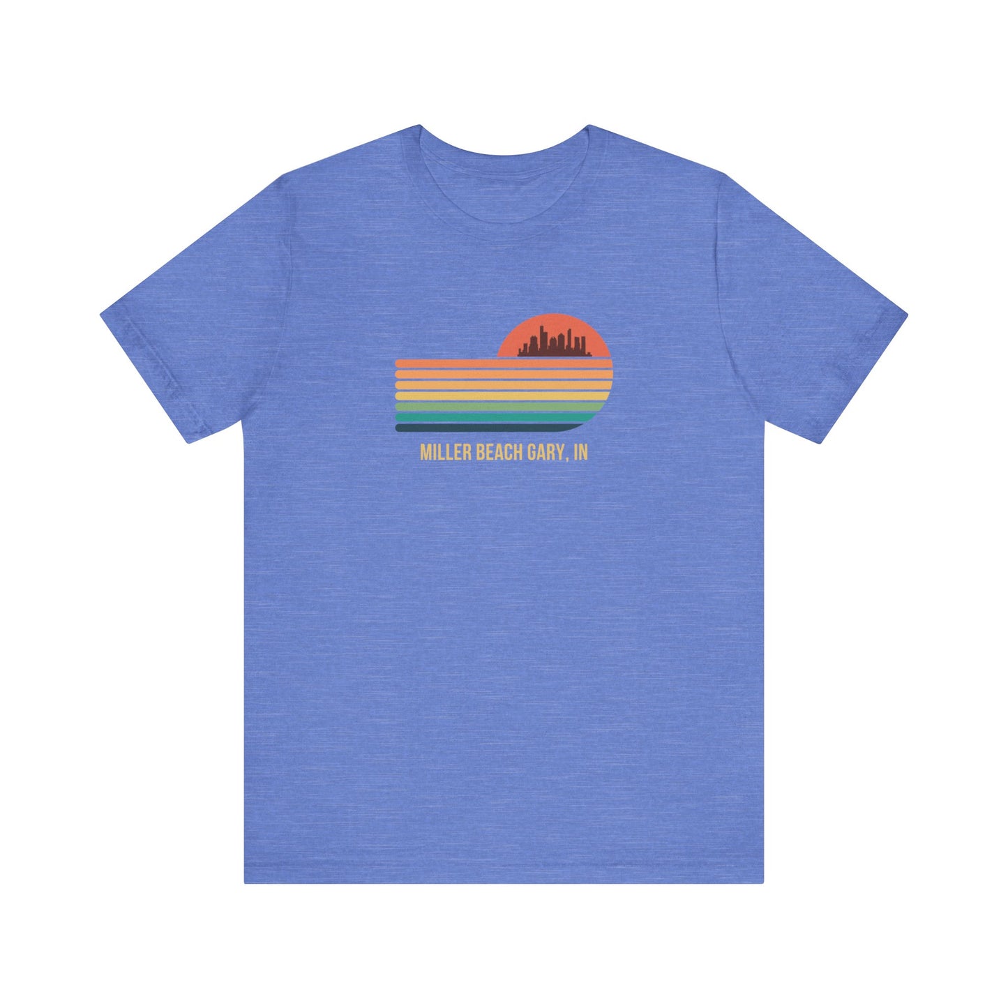 Introducing the Miller Beach Gary, IN Sunset Gradient - Unisex Jersey Short Sleeve Tee by Printify. This stylish blue T-shirt features a circular sunset graphic on the chest, showcasing a black city skyline silhouette against an orange-red sunset with horizontal stripes in green, yellow, and orange. Below the graphic reads "MILLER BEACH GARY, IN." Crafted from soft cotton for extra beachy charm.