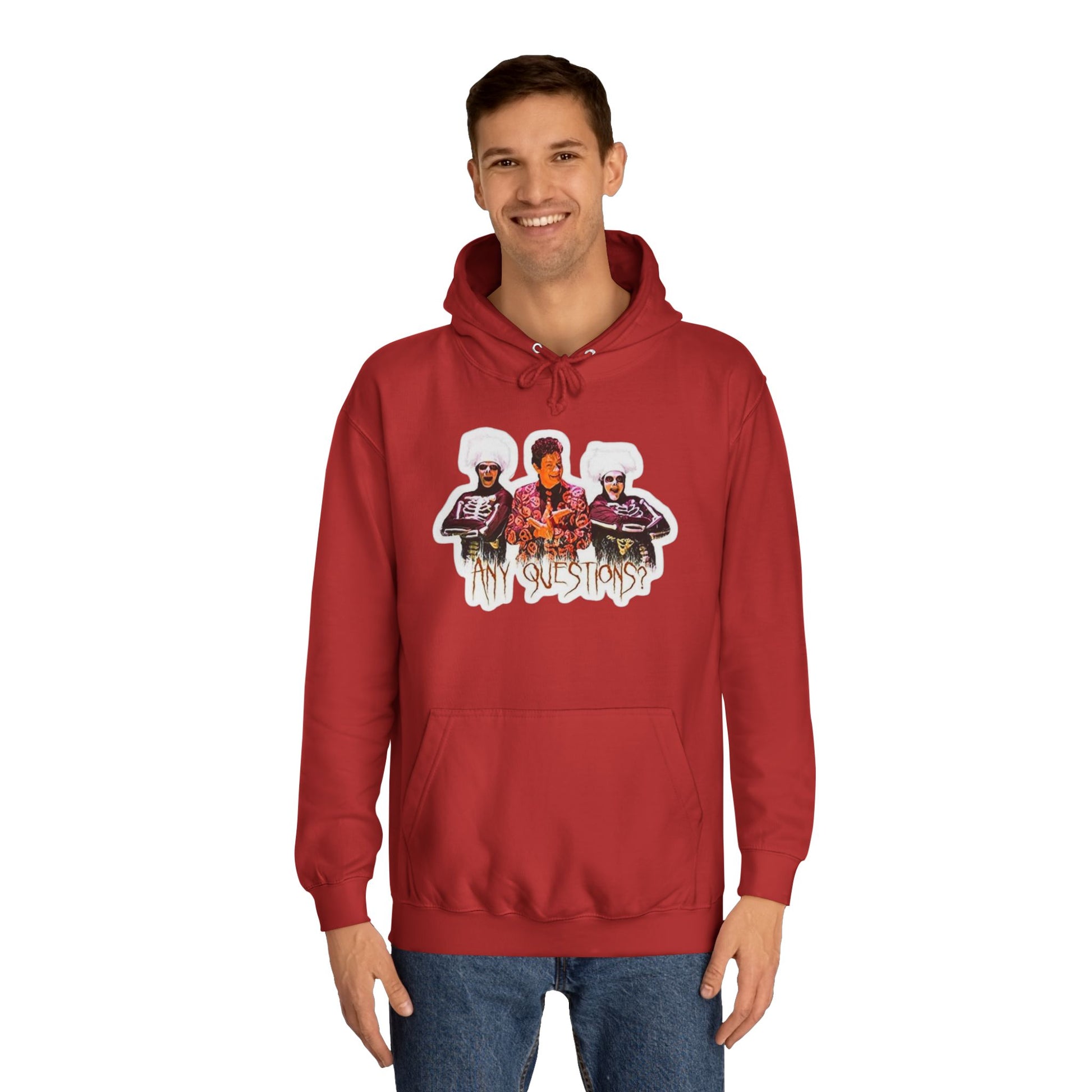 The David S Pumpkins - Any Questions? - Halloween Unisex College Hoodie by Printify is a brown sweatshirt showcasing an illustration of three people. The central figure has red hair, sports a colorful ensemble, and emanates a Halloween vibe, with two flanking figures who have white hair and wear dark attire. Beneath the trio is the phrase "Any Questions?