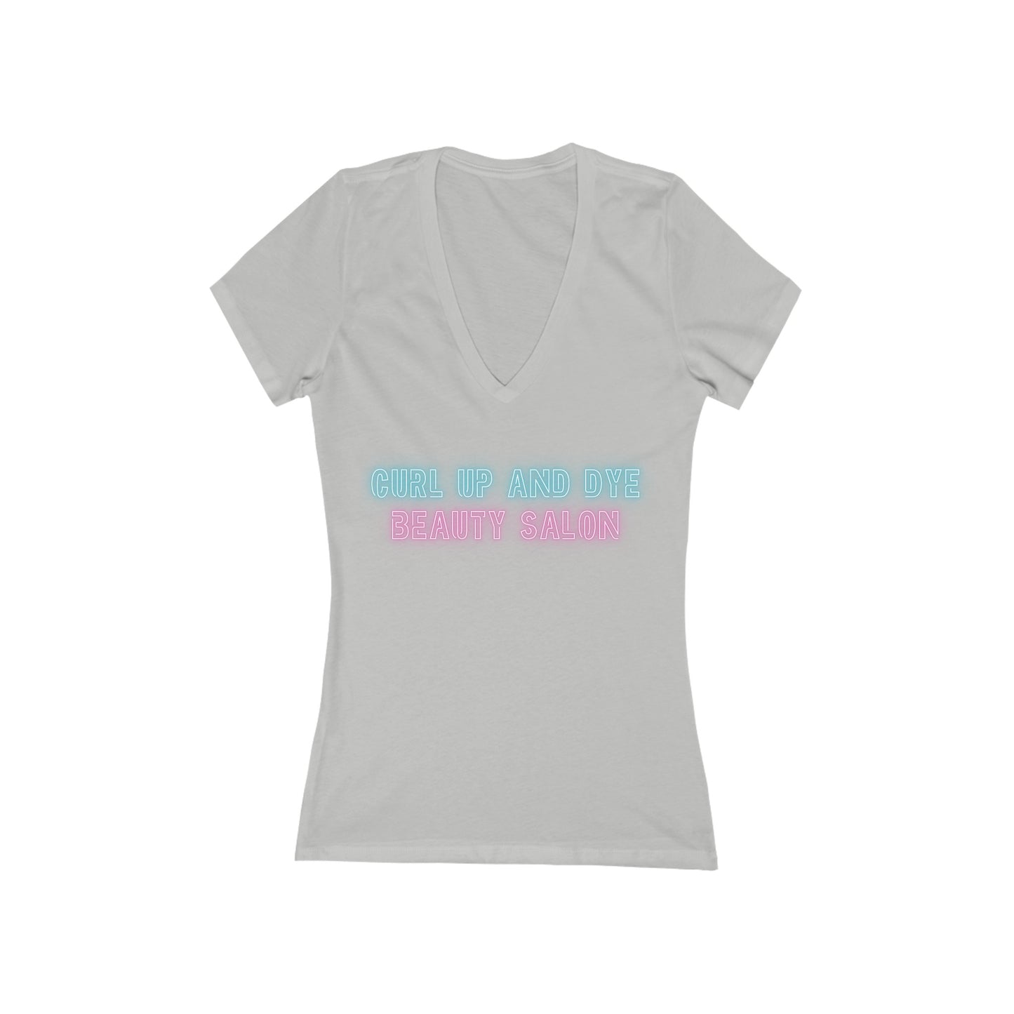 A Printify Blues Brothers Curl Up and Dye Women's Jersey Short Sleeve Deep V-Neck Tee in light gray is shown against a white background. This comfortable wardrobe essential showcases "CURL UP AND DYE" in light blue and "BEAUTY SALON" in light pink printed across the chest, featuring a modern feminine fit.