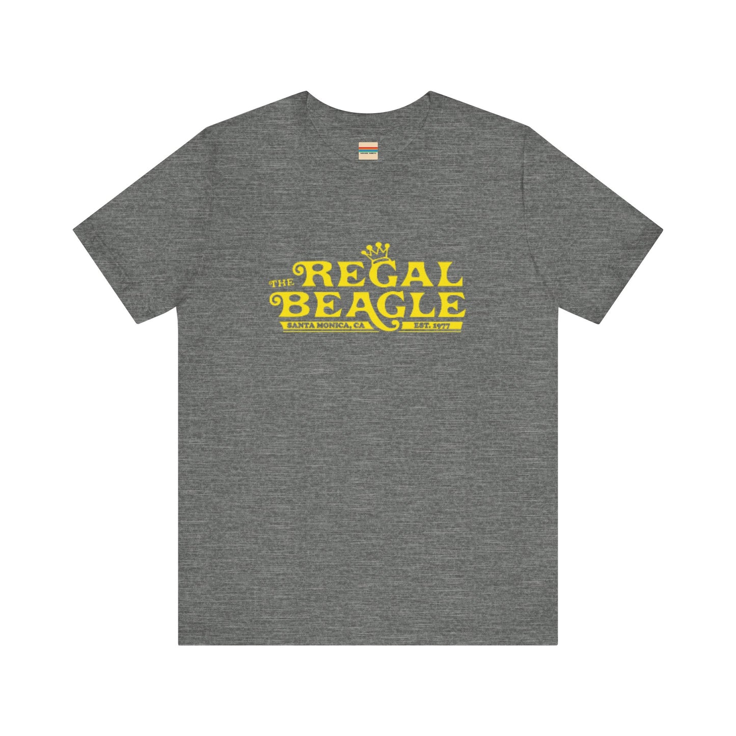 The Printify Regal Beagle - Three's Company Unisex Jersey Short Sleeve Tee, in black, showcases "The Regal Beagle, Santa Monica, CA, Est. 1977" text in a yellow vintage-style font. Crafted from 100% Airlume combed cotton for superior comfort.