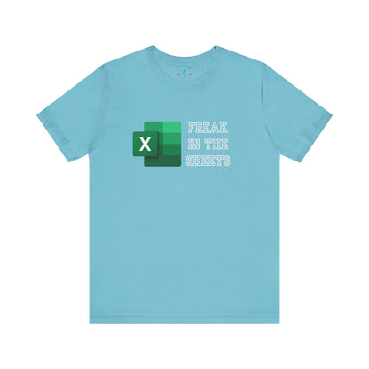 A green Freak in the Sheets - Excel - Unisex Jersey Short Sleeve Tee from Printify, featuring the Microsoft Excel logo on the left. The text next to the logo reads, "FREAK IN THE SHEETS" in white, bold, all-caps letters, making it perfect for spreadsheet enthusiasts. The shirt is laid flat against a plain white background.