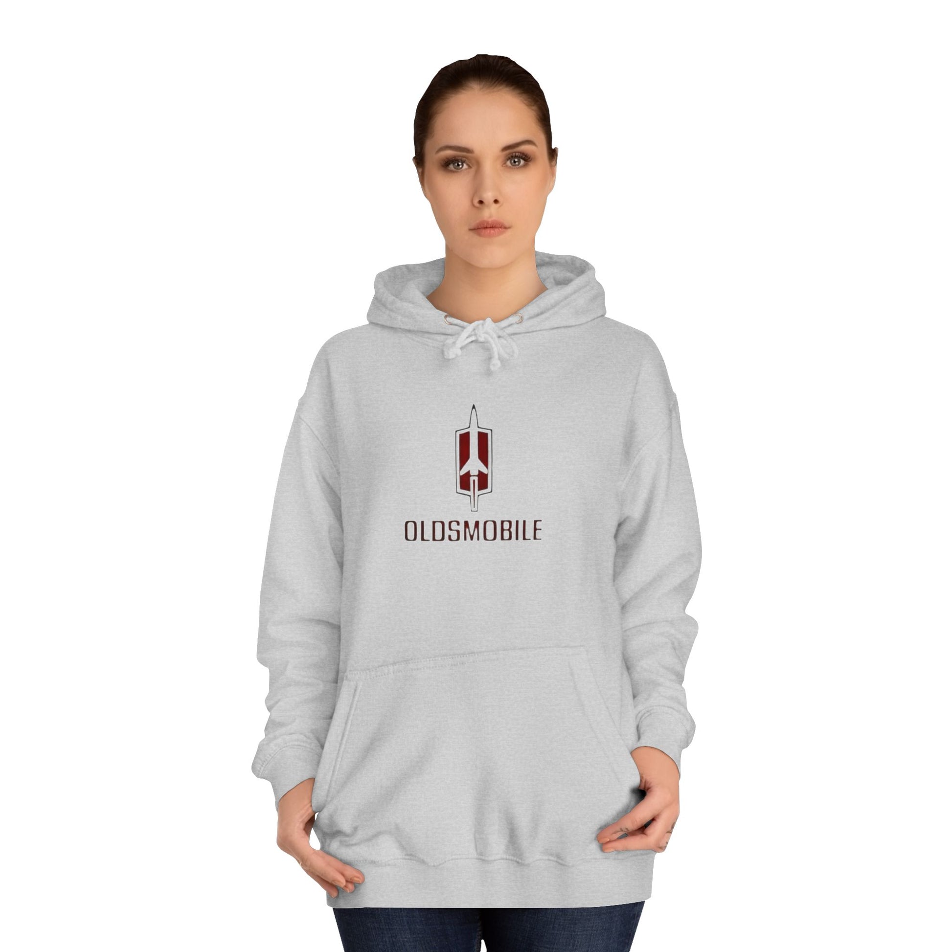 The Oldsmobile 1970s Logo - Unisex College Hoodie by Printify offers a cozy fit in white, featuring a red and black Oldsmobile logo on the front with a stylized rocket above "OLDSMOBILE." It includes a kangaroo pocket and drawstring hood for classic comfort.