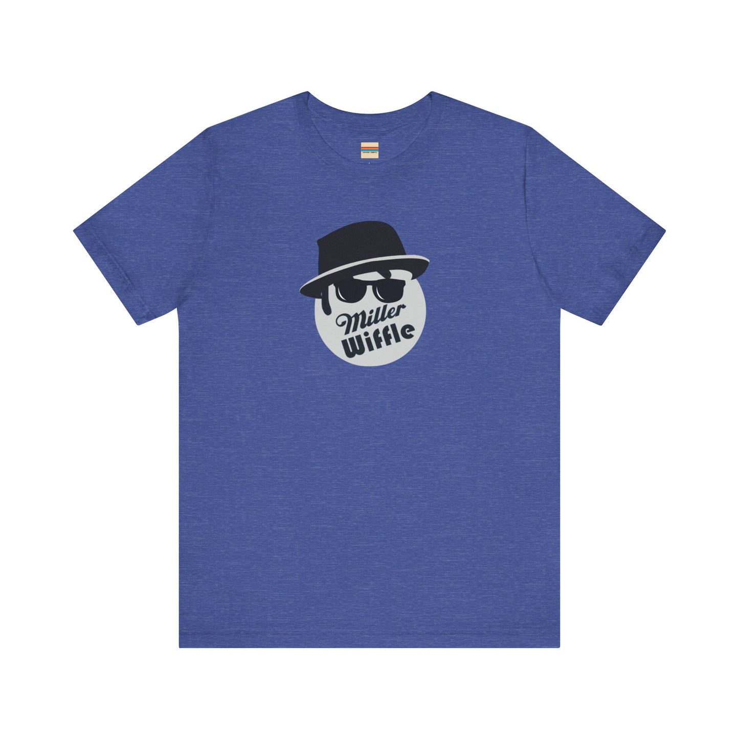 A purple unisex jersey tee from Printify, named the "Miller Wiffel Ball - Blues Brothers - Unisex Jersey Short Sleeve Tee," features a stylized graphic of a ball wearing a black fedora and sunglasses with the text "Miller Wiffel" below it. Another identical soft cotton t-shirt is neatly folded underneath, highlighting its breathable fabric.