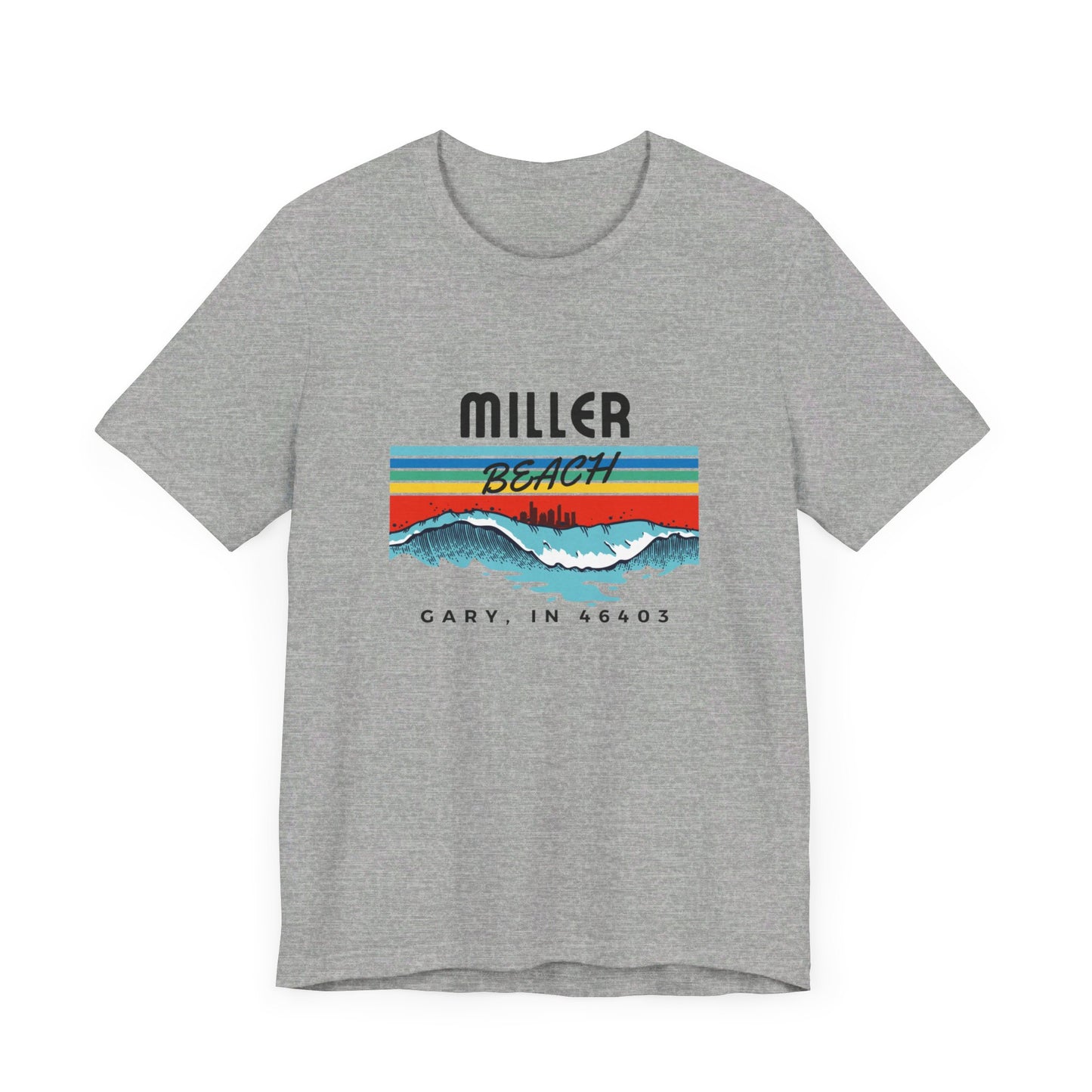 The Miller Beach 46403 Surf Style - Unisex Jersey Short Sleeve Tee by Printify features a retro surf-inspired design on a yellow background. The shirt displays "MILLER BEACH" above waves with a skyline illustration, while "Cary, IN 46403" is printed below the waves. The vibrant design also includes colorful stripes in shades of blue, red, and orange.