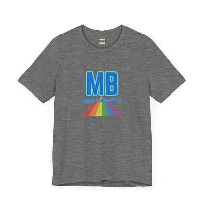 The Miller Beach Pride - Unisex Jersey Short Sleeve Tee by Printify is a white shirt made from 100% Airlume combed cotton. It showcases a design with large, bold blue letters "MB" at the top. Beneath it, the text "MILLER BEACH GARY, IN" is written in blue. A colorful, triangular rainbow graphic extends downward from the text, symbolizing Miller Beach pride.