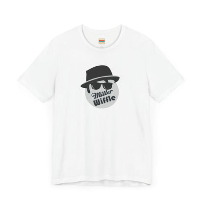 A purple unisex jersey tee from Printify, named the "Miller Wiffel Ball - Blues Brothers - Unisex Jersey Short Sleeve Tee," features a stylized graphic of a ball wearing a black fedora and sunglasses with the text "Miller Wiffel" below it. Another identical soft cotton t-shirt is neatly folded underneath, highlighting its breathable fabric.