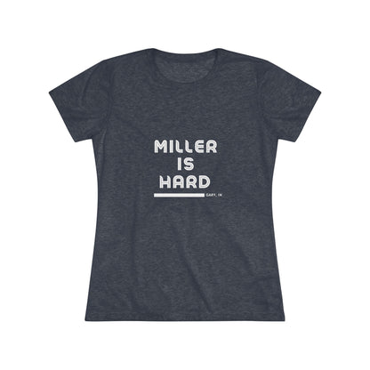 The Miller is Hard - Miller Beach Women's Triblend Tee by Printify features unique red coloring with white text that reads "MILLER IS HARD" and "GARY, IN" below, showcasing distinctive lettering spacing and alignment. Made from ultra-soft fabric, this shirt ensures a comfortable fit with a simple, casual design.