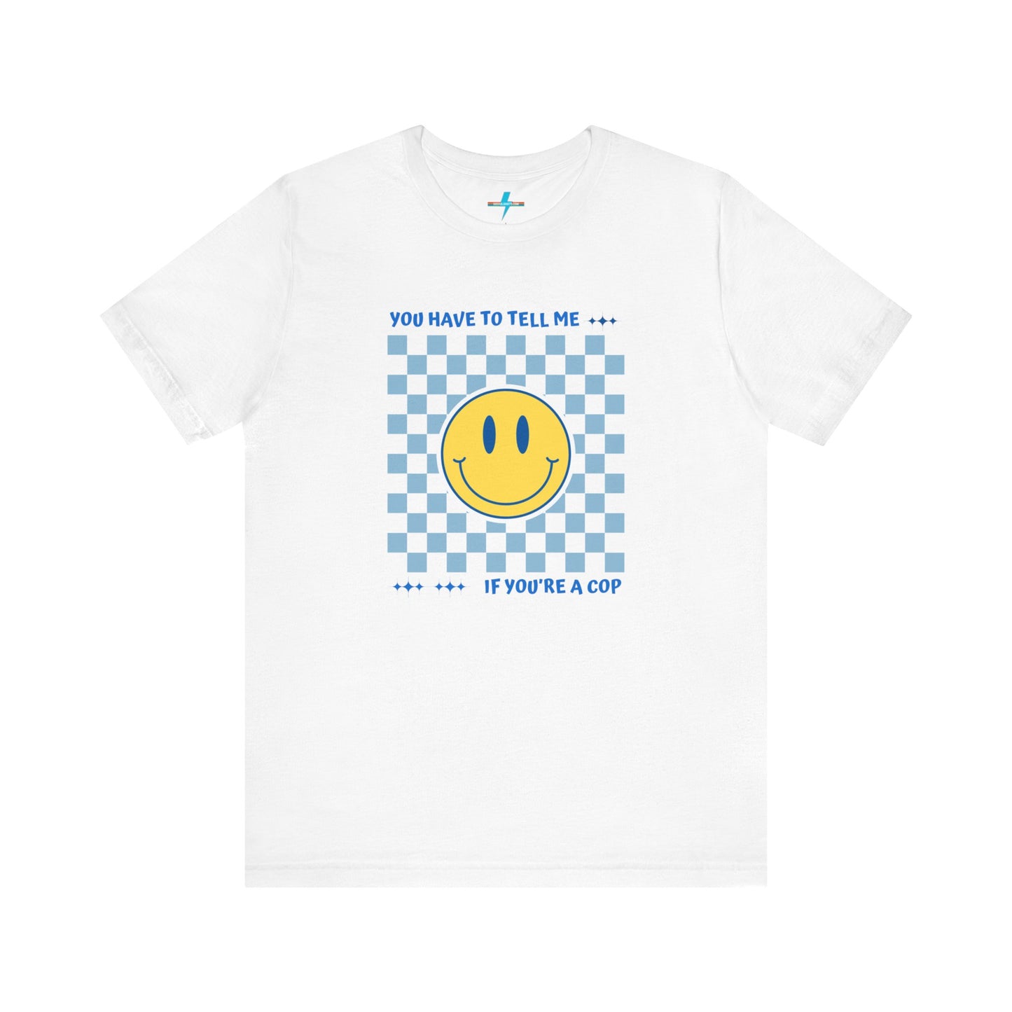 A light yellow unisex jersey short sleeve tee from Printify featuring a blue and yellow checkerboard pattern with a large yellow smiley face in the center. The shirt displays blue text above and below the pattern that reads, "You have to tell me if you're a cop." It's made from 100% Airlume combed and ring-spun cotton.