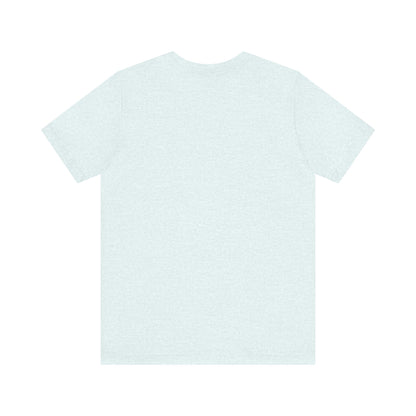 A light blue Printify "The Tinder Box 1980s" unisex jersey short sleeve tee featuring the "Tinder Box" logo in the center. The logo consists of a dark shield with the words "Tinder Box" in white text, with a small flame icon replacing the dot above the "i".
