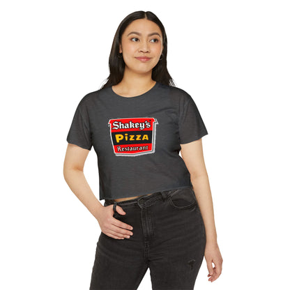 The Shakey's Pizza - Women's Festival Crop Top from Printify is a light blue garment that proudly displays the iconic Shakey's Pizza logo on the chest. Featuring retro-style red and black signage with text in white, yellow, and red that reads "Shakey's Pizza Restaurant," this crop top exudes a vintage-inspired charm.