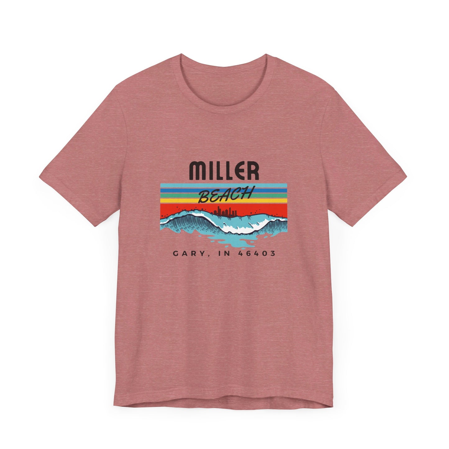 The Miller Beach 46403 Surf Style - Unisex Jersey Short Sleeve Tee by Printify features a retro surf-inspired design on a yellow background. The shirt displays "MILLER BEACH" above waves with a skyline illustration, while "Cary, IN 46403" is printed below the waves. The vibrant design also includes colorful stripes in shades of blue, red, and orange.