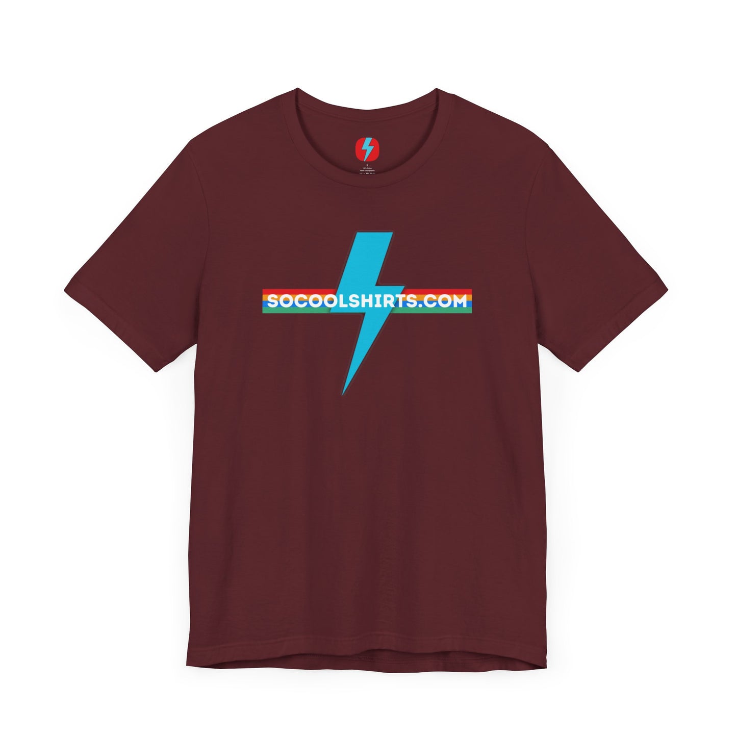 This unisex jersey short sleeve tee by Printify features a striking maroon color with a central light blue lightning bolt design. The text "SOCOOLSHIRTS.COM" is prominently displayed across the lightning bolt in white letters, set against a multicolored background that exudes retro vibes. The shirt is shown laid flat on a white backdrop.