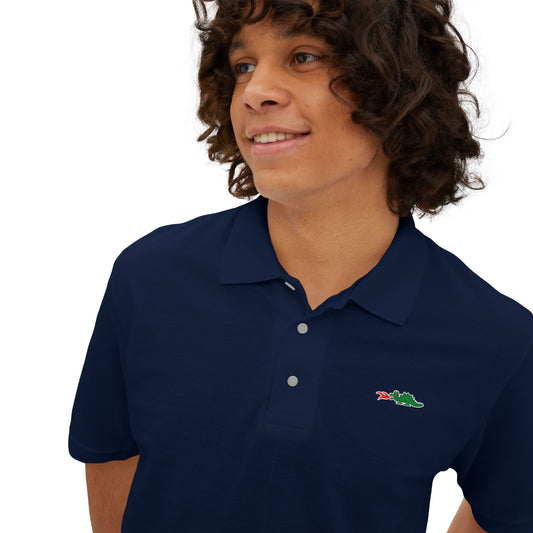 A person with curly hair wearing a navy blue Printify Braggin' Dragon - 1980s Sears Men's Piqué Polo, featuring a small embroidered dragon logo on the left chest, smiles against a plain white background.