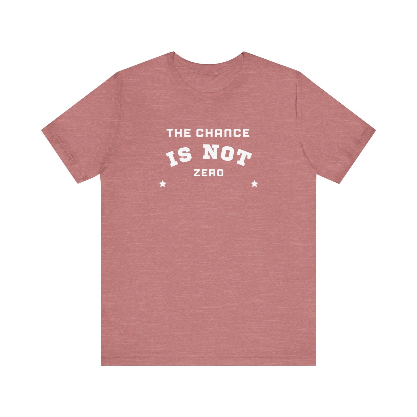 Folded light red Unisex Jersey Short Sleeve Tee from Printify, featuring bold white text that reads "THE CHANCE IS NOT ZERO" along with two star illustrations. This motivational T-shirt, made from breathable fabric, is neatly stacked with another identical shirt underneath.