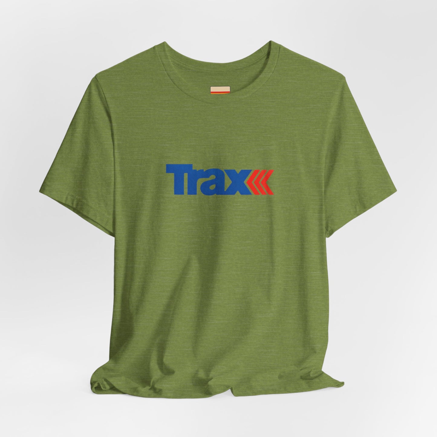 A gray unisex jersey short sleeve tee from Printify, inspired by retro 1980s Kmart style. The "Trax" logo is printed in blue letters, followed by three red arrows pointing to the right. This classic Trax Brand T-shirt is laid flat against a white background, capturing nostalgic fashion vibes.