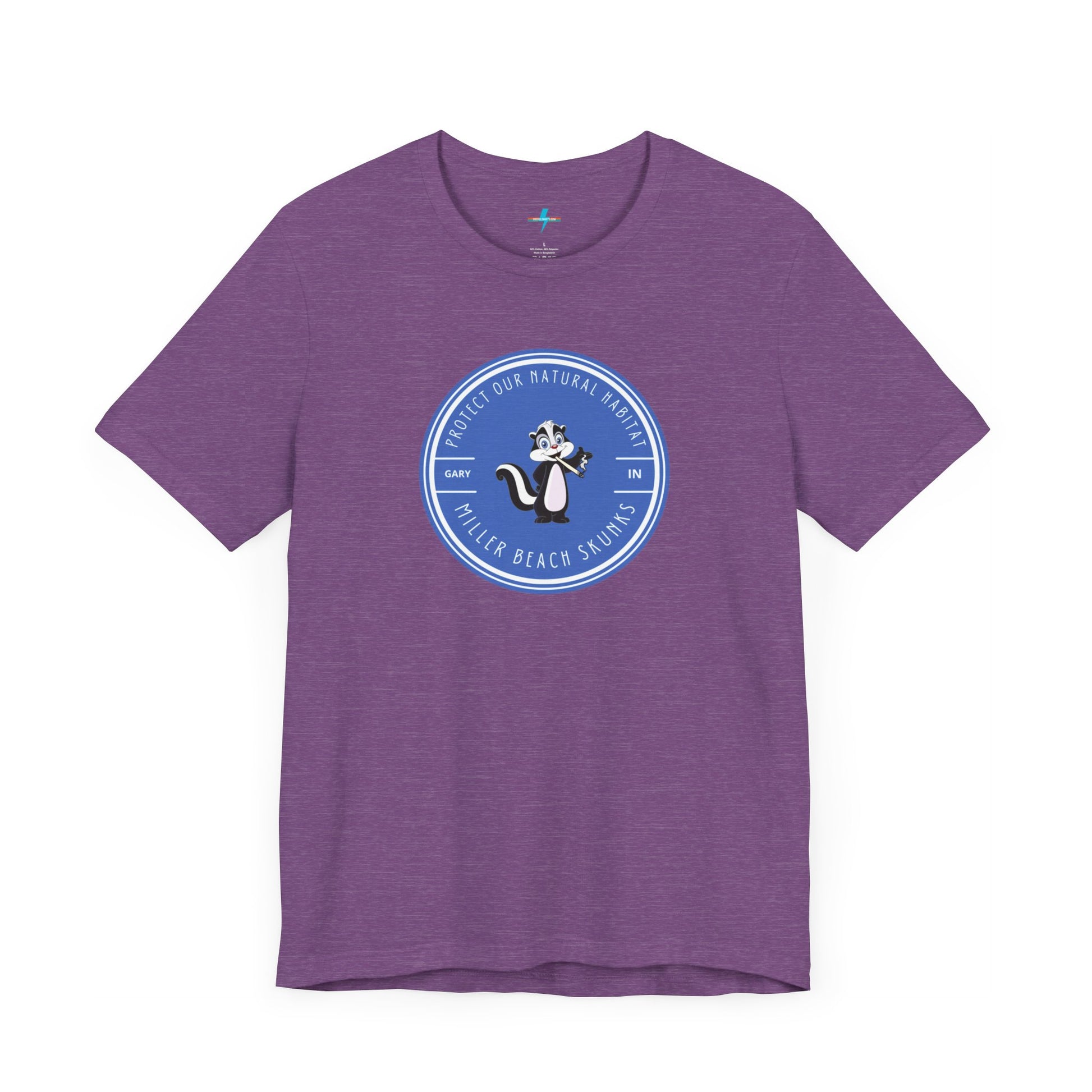 The Printify Miller Beach Skunks - Unisex Jersey Short Sleeve Tee is a gray T-shirt that features a circular blue logo at the center. Inside the logo, there is an illustration of a skunk with the text "Protect Our Habitat" and "Miller Beach Skunks" around the border, promoting environmental consciousness. The upper left part of the logo reads "Gary, IN.