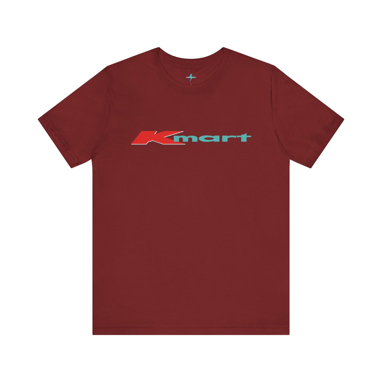 The Printify KMart Logo 1980s Retro - Unisex Jersey Short Sleeve Tee in dark gray features a nostalgic design with the iconic logo in red and teal across the chest. This short-sleeve crew-neck shirt exudes vintage charm with its simple, classic look.