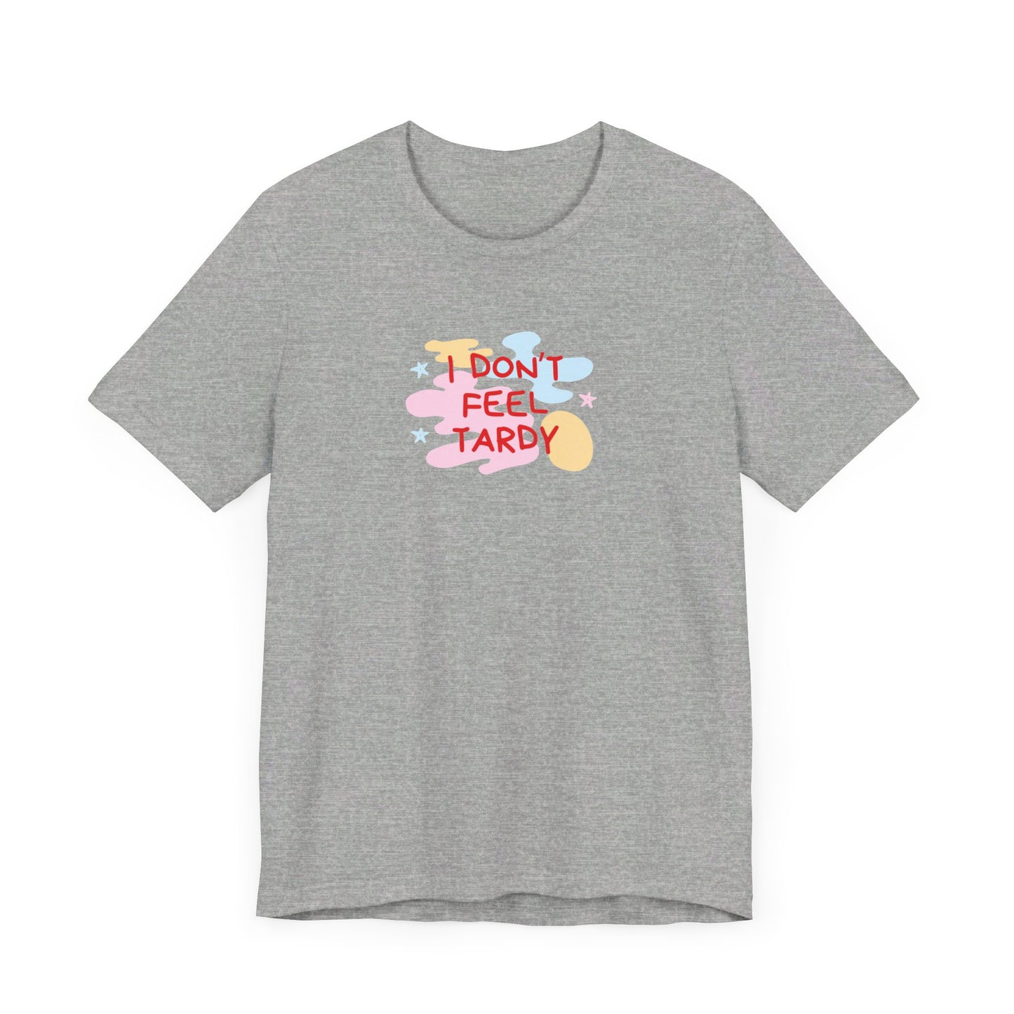 The "I Don't Feel Tardy - 1980s Retro - Unisex Jersey Short Sleeve Tee" from Printify is a light pink jersey shirt that features the bold, colorful text "I DON'T FEEL TARDY" prominently at its center. This design exudes retro vibes with small star shapes and abstract splashes of blue, yellow, and pink, laid flat against a plain background to channel pure Van Halen T-shirt energy.