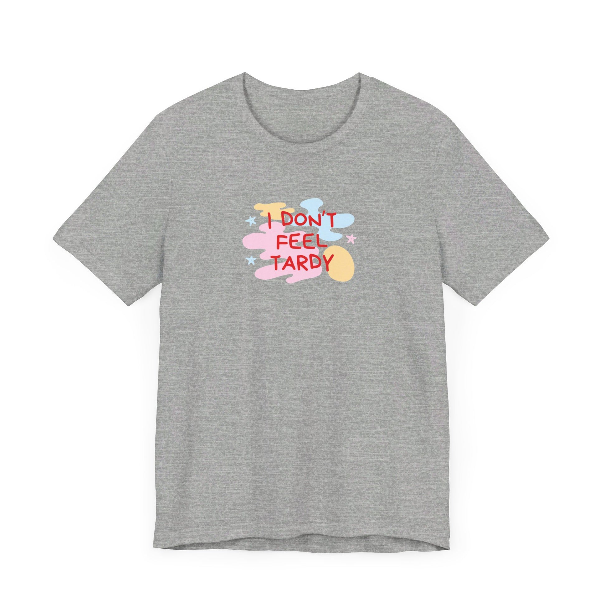 The "I Don't Feel Tardy - 1980s Retro - Unisex Jersey Short Sleeve Tee" from Printify is a light pink jersey shirt that features the bold, colorful text "I DON'T FEEL TARDY" prominently at its center. This design exudes retro vibes with small star shapes and abstract splashes of blue, yellow, and pink, laid flat against a plain background to channel pure Van Halen T-shirt energy.