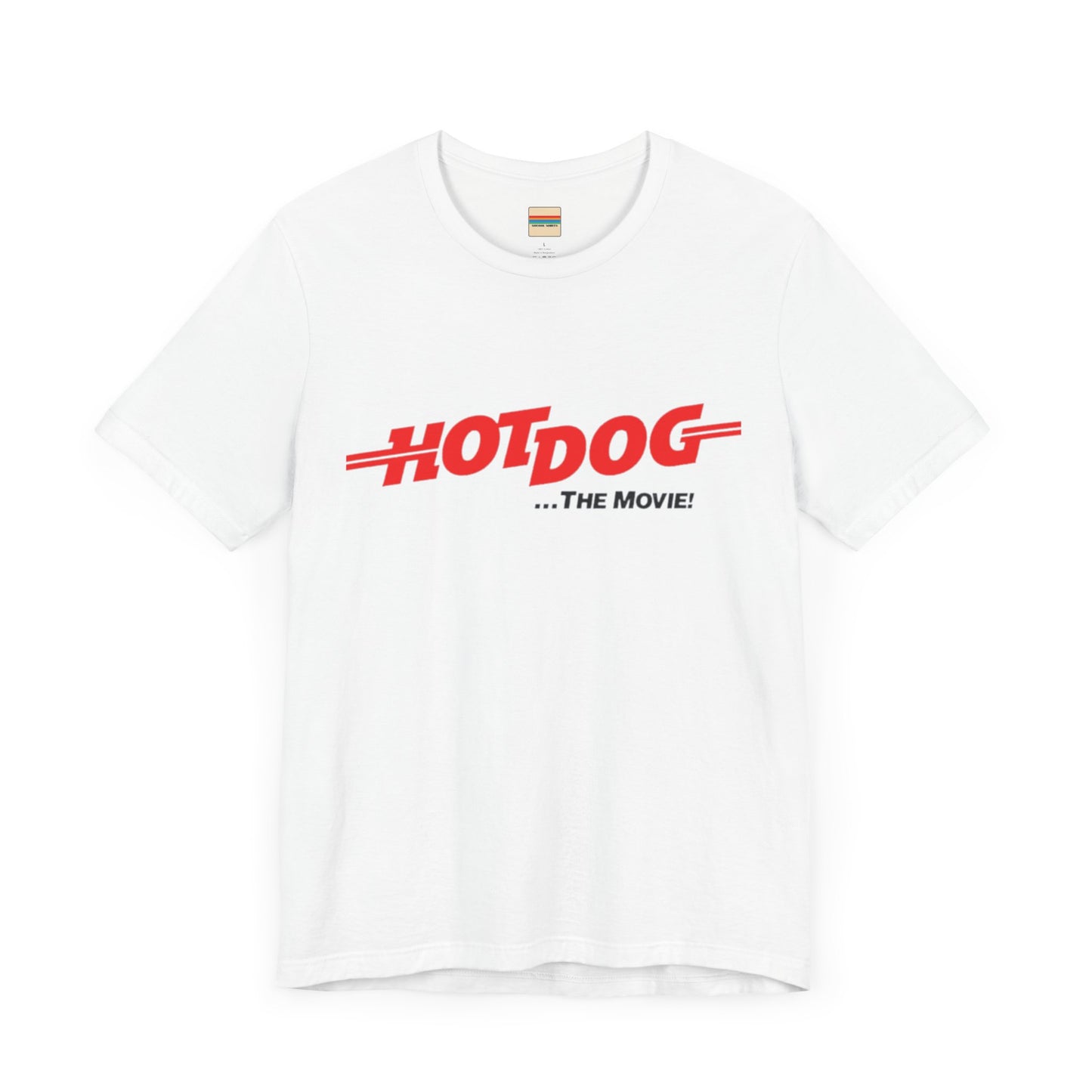 A smiling man and woman interact while wearing matching yellow "Hot Dog The Movie 1984 - Unisex Jersey Short Sleeve Tee" by Printify, featuring bold red "HOT DOG THE MOVIE" text. Their vibrant tees perfectly complement their blue jeans, with the man casually having his hands in his pockets and the woman resting one hand on his shoulder.