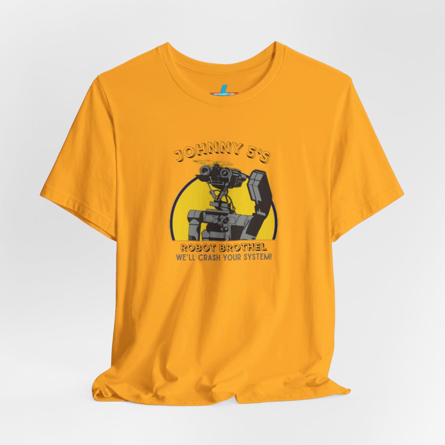 A vibrant orange unisex jersey short sleeve tee from Printify showcases a graphic of a small robot detailed in black and grey. Above the robot, retro robotics text reads "Johnny 5’s Robot Br*thel," while below, it says "We'll Crash Your System!" in a smaller font.