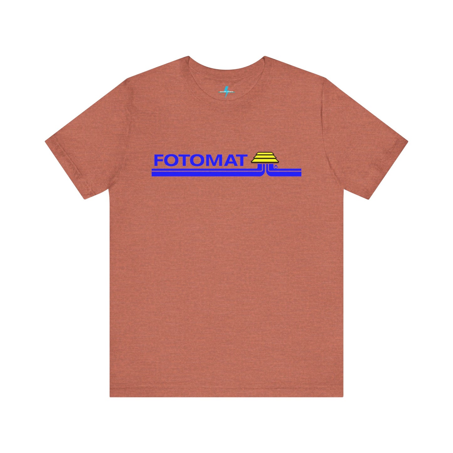 The Fotomat 1970s Retro T-Shirt by Printify is a dark gray short-sleeve shirt that features the word "FOTOMAT" in bold blue capital letters and a blue and yellow graphic design resembling layered lines and an upside-down triangle. This Tshirt captures the essence of 80s nostalgia with its centered, retro design.