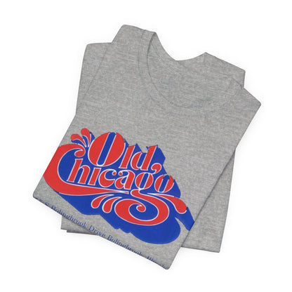 The "Old Chicago Mall Bolingbrook 1980s Retro - Unisex Jersey Short Sleeve Tee" from Printify is a gray T-shirt showcasing a vintage design with the text "Old Chicago" in blue and red. Beneath the main text, the address "355 S. Bolingbrook Drive, Bolingbrook, Illinois" appears in smaller font, evoking 80s nostalgia of the Old Chicago Mall. The shirt is displayed against a white background.