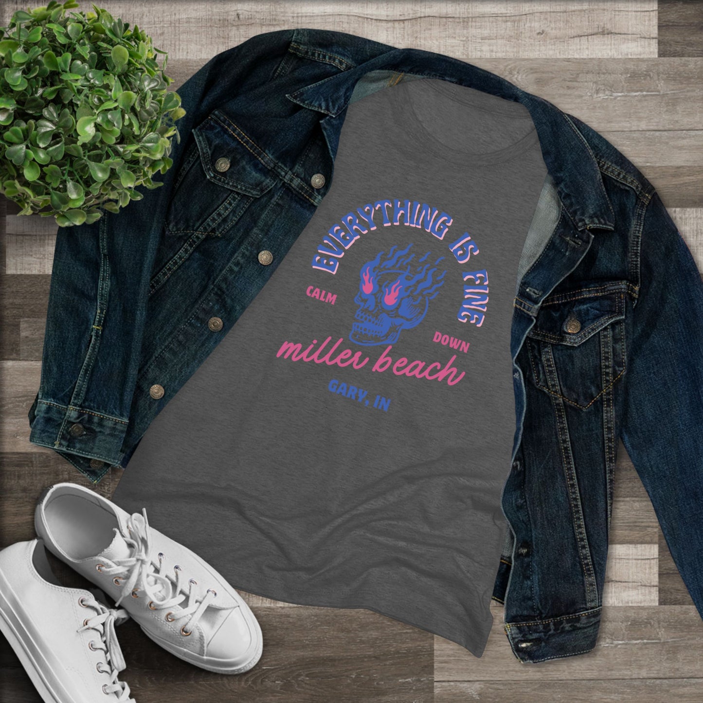 Introducing the Miller Beach - Everything is Fine - Calm Down Women's Triblend Tee by Printify – a dark gray, relaxed-fit shirt adorned with a neon blue and pink flaming skull at its center. Above the skull, the text reads "Everything is Fine" and "Calm Down," while below it says "Miller Beach, Gary, IN" in a stylish script font. This tee captures a cool vintage aesthetic perfect for casual wear.