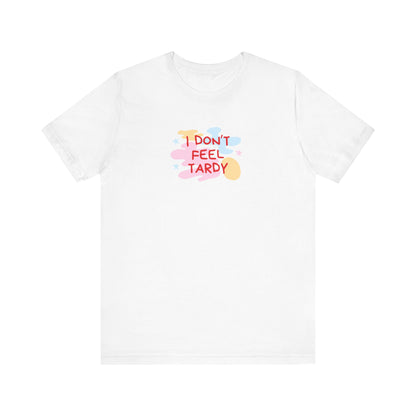 The "I Don't Feel Tardy - 1980s Retro - Unisex Jersey Short Sleeve Tee" from Printify is a light pink jersey shirt that features the bold, colorful text "I DON'T FEEL TARDY" prominently at its center. This design exudes retro vibes with small star shapes and abstract splashes of blue, yellow, and pink, laid flat against a plain background to channel pure Van Halen T-shirt energy.