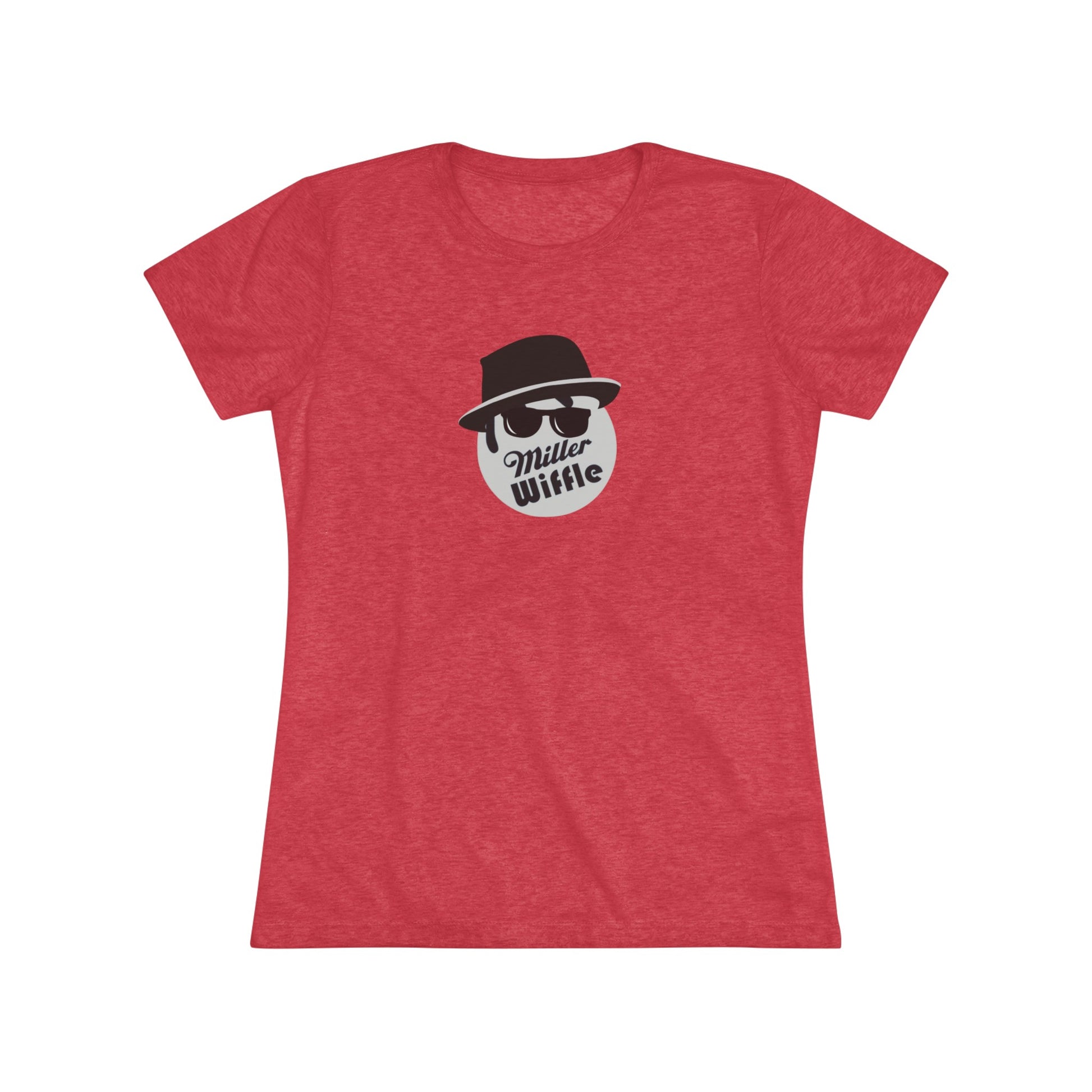 A cozy red t-shirt, the Miller Wiffel Ball - Blues Brothers - Women's Triblend Tee by Printify, features a graphic of a masked face wearing a fedora hat and sunglasses, along with the text "Miller Wiffle." The t-shirt is displayed on a wooden floor, paired with a denim jacket, white sneakers, and a potted green plant to create a vintage look.