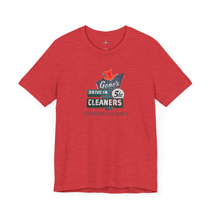 A unisex Jersey short sleeve tee from Printify featuring a light grey color with a retro-style graphic in the center. The design showcases text that reads "Gene's Drive In Cleaners, 5th," along with the address "12401 Vincennes Blue Island IL" in a blend of vintage fonts and colors, evoking the classic Chicago Fire-era vintage sign aesthetic.