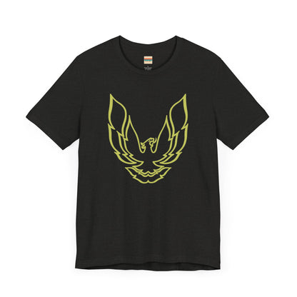 The Pontiac Trans Am Phoenix Shirt - Unisex Jersey Short Sleeve Tee by Printify is a classic black T-shirt that showcases a stylized yellow phoenix design on the front, reminiscent of the iconic Pontiac Trans Am. The shirt is displayed laid flat against a white background.