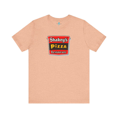 A black Shakey's Pizza - 1980s Retro Logo - Unisex T-Shirt by Printify hangs against a white background. The shirt features a colorful graphic with the text "Shakey's Pizza Restaurant" in white, yellow, and black lettering on a red background, resembling vintage pizza joints signage. This retro tee brings nostalgic vibes of classic pizzerias.