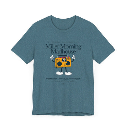 This Printify unisex jersey short sleeve tee in Sand Dune features a playful boombox cartoon character with arms, legs, and sunglasses. Emblazoned with "Miller Morning Madhouse," it highlights podcast details from "The School Podcast Presents.