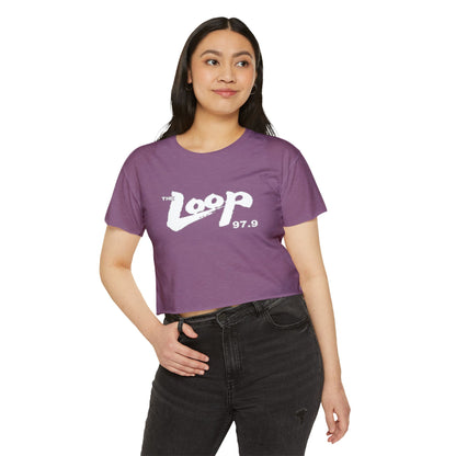 Printify's Women's Festival Crop Top features a grey design with short sleeves and a round neckline. The crop top displays the text "The Loop 97.9" in white, with the word "Loop" styled in a brushstroke-like font—ideal for fans of Chicago’s iconic rock radio station who appreciate retro fashion.