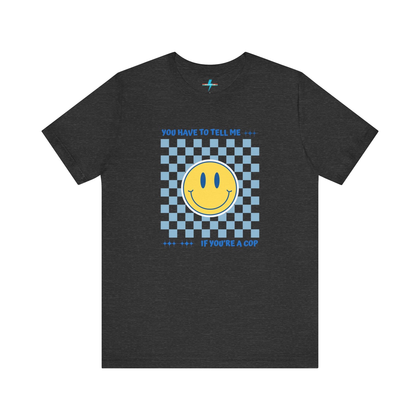 A light yellow unisex jersey short sleeve tee from Printify featuring a blue and yellow checkerboard pattern with a large yellow smiley face in the center. The shirt displays blue text above and below the pattern that reads, "You have to tell me if you're a cop." It's made from 100% Airlume combed and ring-spun cotton.