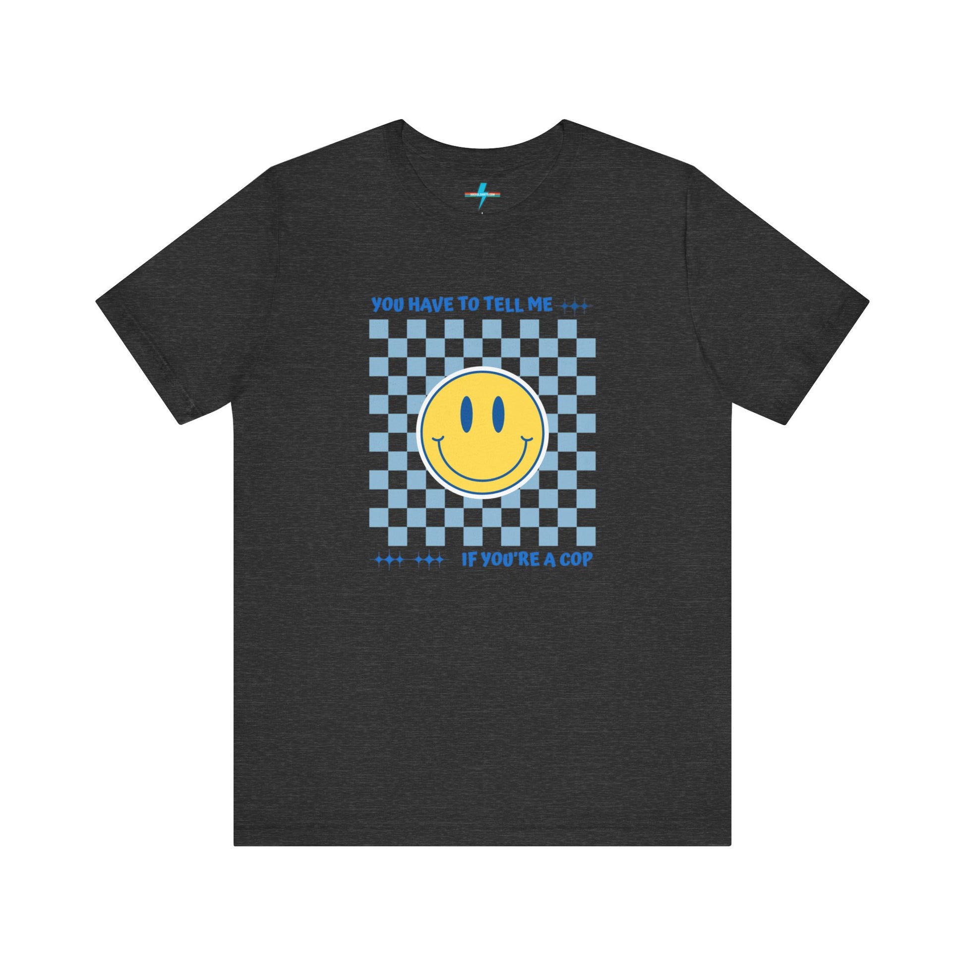 A light yellow unisex jersey short sleeve tee from Printify featuring a blue and yellow checkerboard pattern with a large yellow smiley face in the center. The shirt displays blue text above and below the pattern that reads, "You have to tell me if you're a cop." It's made from 100% Airlume combed and ring-spun cotton.