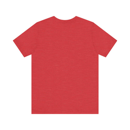 A light blue Printify "The Tinder Box 1980s" unisex jersey short sleeve tee featuring the "Tinder Box" logo in the center. The logo consists of a dark shield with the words "Tinder Box" in white text, with a small flame icon replacing the dot above the "i".
