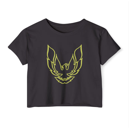 The Pontic Trans Am - Women's Festival Crop Top by Printify is a green heathered crop top featuring a large, stylized yellow eagle graphic with wings spread wide on the front, reminiscent of the Pontiac Phoenix Trans Am logo. With a simple crew neck and short sleeves, this top is ideal for vintage enthusiasts.