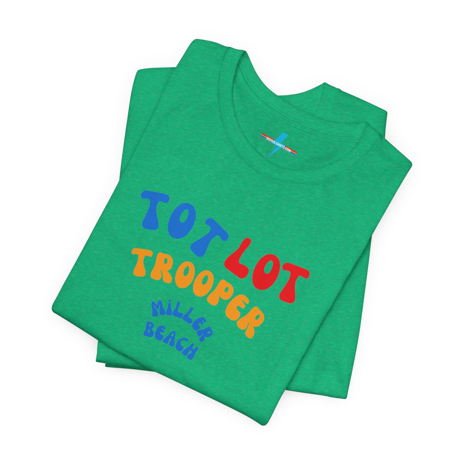 A green unisex jersey short sleeve tee from Printify, featuring colorful text on the front that reads "TOT LOT TROOPER MILLER BEACH" in blue, red, yellow, and orange letters. The shirt is displayed against a plain white background.