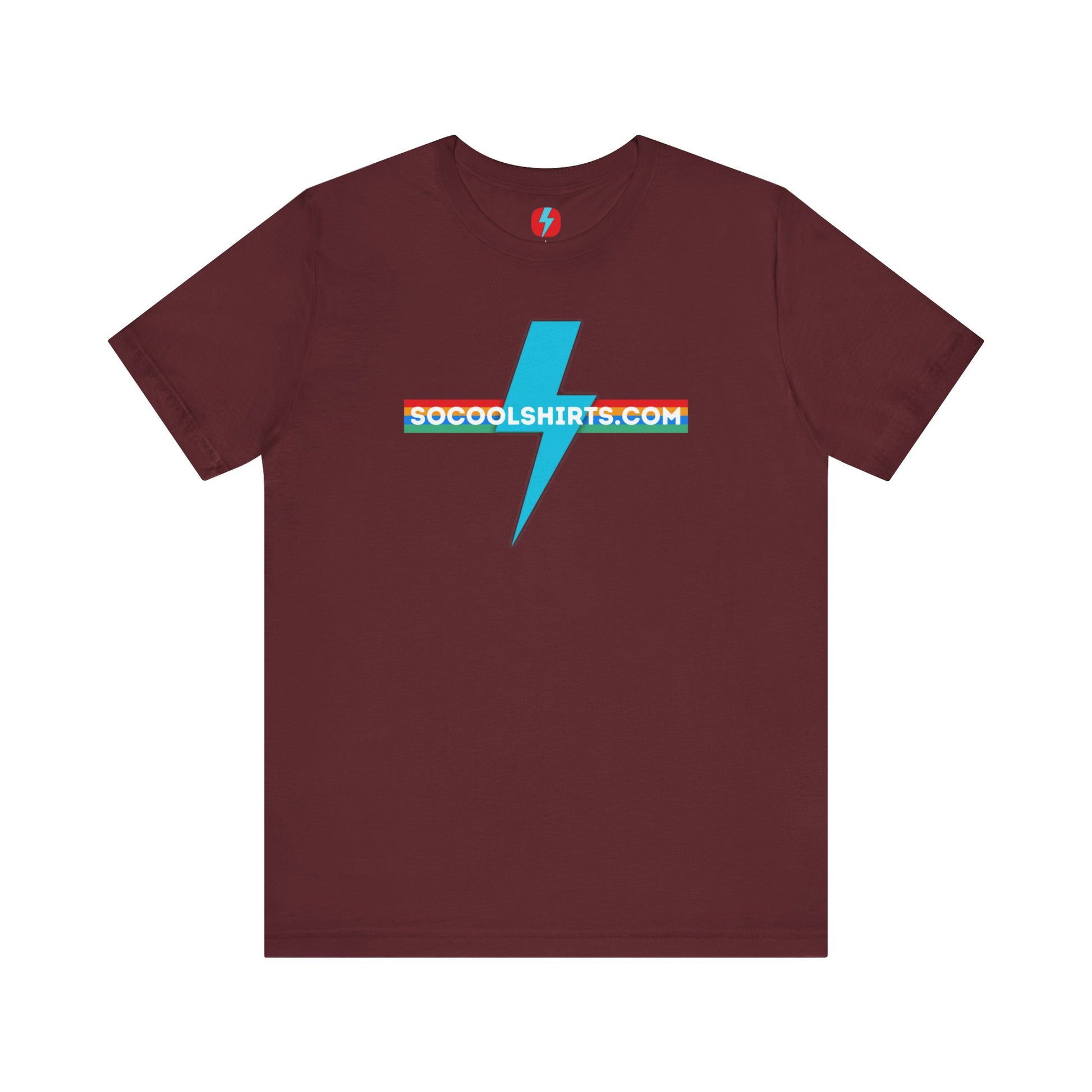 This unisex jersey short sleeve tee by Printify features a striking maroon color with a central light blue lightning bolt design. The text "SOCOOLSHIRTS.COM" is prominently displayed across the lightning bolt in white letters, set against a multicolored background that exudes retro vibes. The shirt is shown laid flat on a white backdrop.