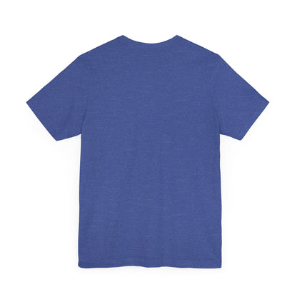 A purple unisex jersey tee from Printify, named the "Miller Wiffel Ball - Blues Brothers - Unisex Jersey Short Sleeve Tee," features a stylized graphic of a ball wearing a black fedora and sunglasses with the text "Miller Wiffel" below it. Another identical soft cotton t-shirt is neatly folded underneath, highlighting its breathable fabric.