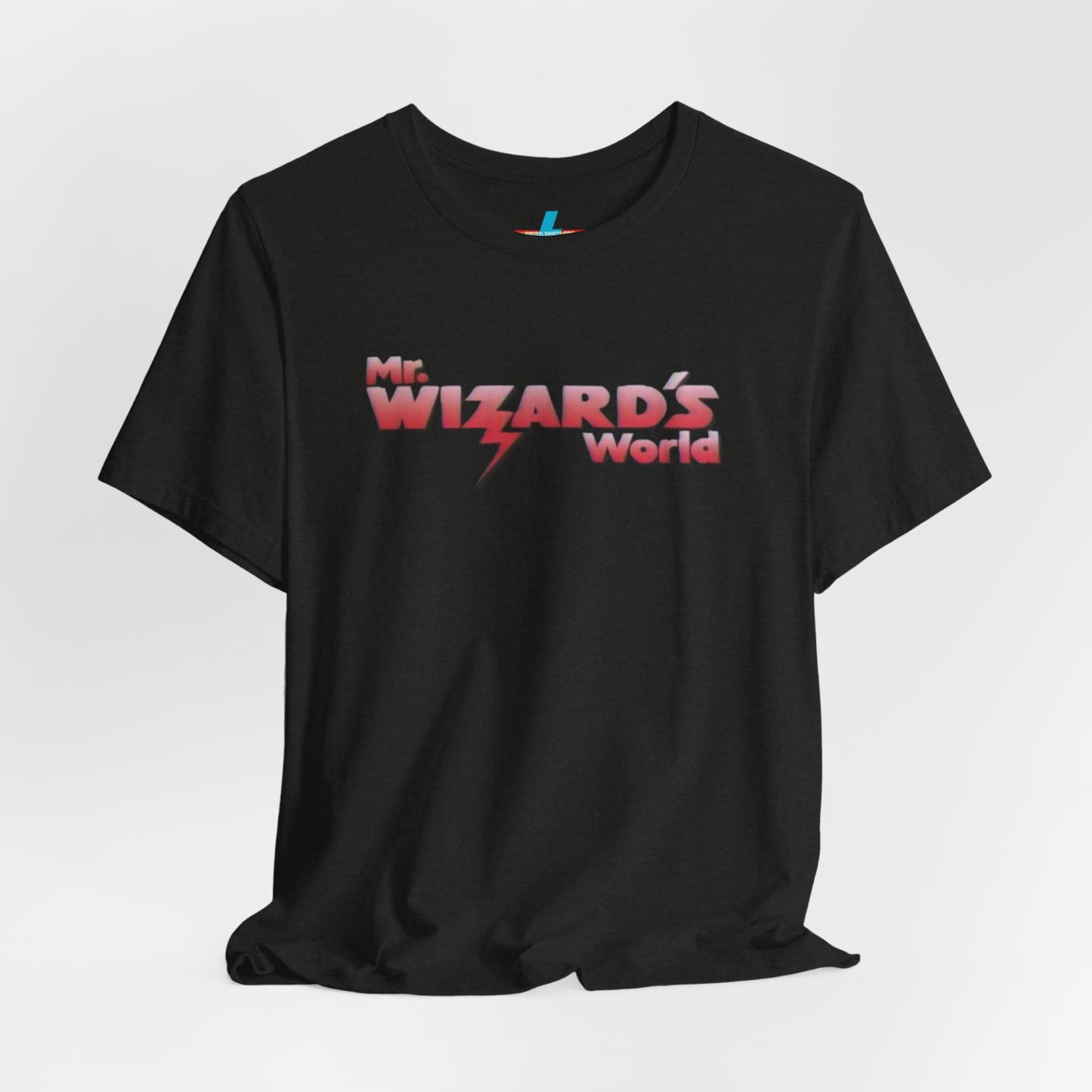 A purple Mr. Wizard's World T-shirt from Printify, featuring bold gradient red and white text with a lightning bolt through the letter "A" in "Wizard." Ideal for science enthusiasts and fans of the iconic 1980s Nickelodeon show, this unisex jersey short sleeve tee is displayed against a plain white background.