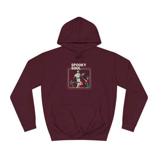 Get into the Halloween spirit with Printify's Spooky Soul - Halloween Unisex College Hoodie in maroon. This hoodie features a retro-style graphic of a dancing mummy and two skeletons, making it ideal for anyone who enjoys the playful thrill of a haunted house adventure.