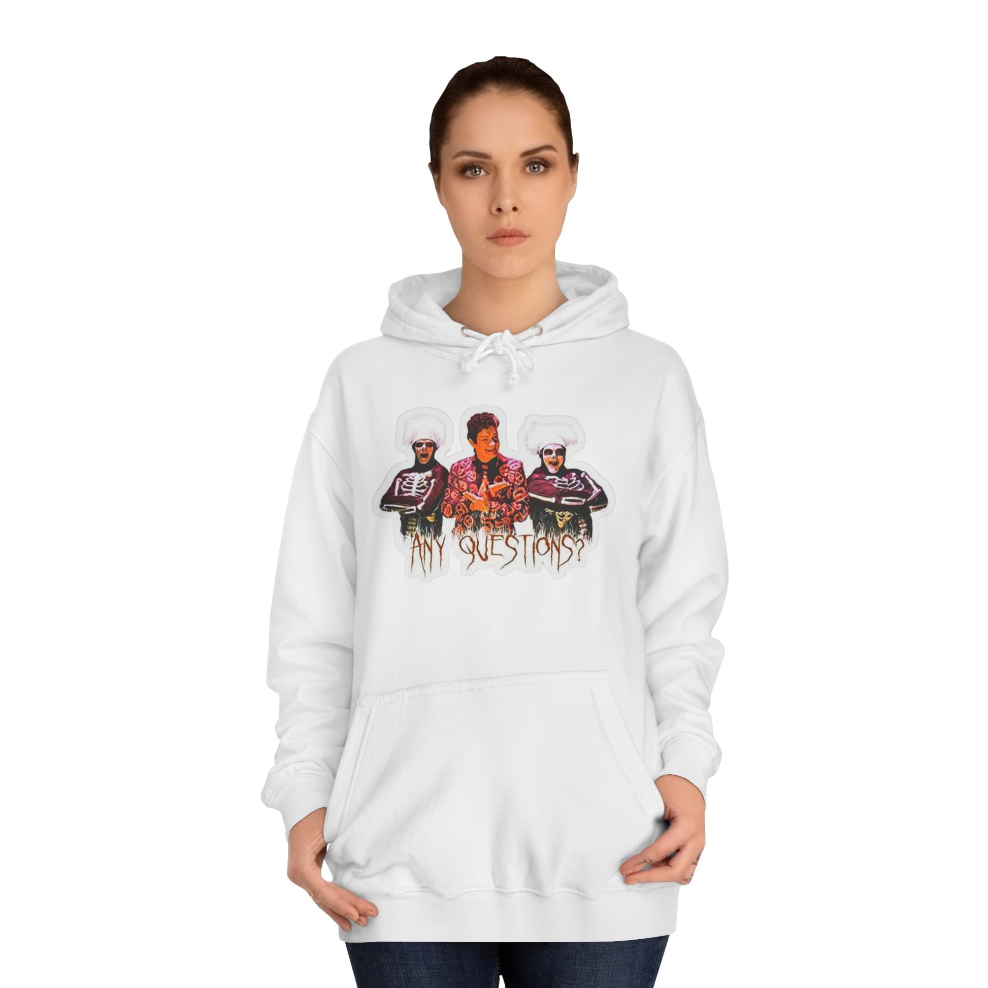 The David S Pumpkins - Any Questions? - Halloween Unisex College Hoodie by Printify is a brown sweatshirt showcasing an illustration of three people. The central figure has red hair, sports a colorful ensemble, and emanates a Halloween vibe, with two flanking figures who have white hair and wear dark attire. Beneath the trio is the phrase "Any Questions?