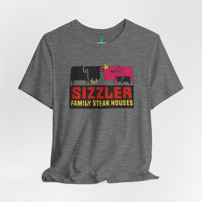 The "Sizzler Family Steakhouses - Retro 1981 Logo - Unisex Jersey Short Sleeve Tee" by Printify is a gray t-shirt showcasing a retro-style graphic with two black and pink cows, a cactus, and the text "Sizzler Family Steak Houses" in vibrant red and yellow. Ideal for any retro enthusiast, this design evokes nostalgia reminiscent of vintage restaurant logos from 1981.