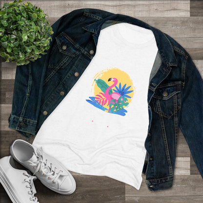 A women's triblend tee from Printify, the Miller Beach Flamingo features a blue color and "Miller Beach Gary, IN 46403" text with a vibrant design of a flamingo amidst tropical foliage for a vintage aesthetic. This t-shirt is showcased on a wooden surface alongside a denim jacket, white sneakers, and a potted plant.