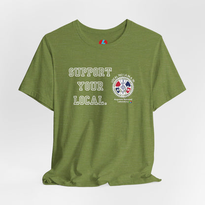 A blue unisex jersey short sleeve tee from Printify showcases the text "SUPPORT YOUR LOCAL" in bold white capital letters on the front. Additionally, it features a white and red graphic emblem for the Atomic Trades & Labor Council, AFL-CIO, Local 148 with "Argonne National Laboratory" text beneath it. Wear this Support Your Local - IAMAW 742 shirt to show your union solidarity.